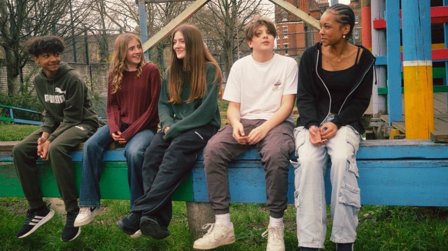 Teenagers sitting in a playground.