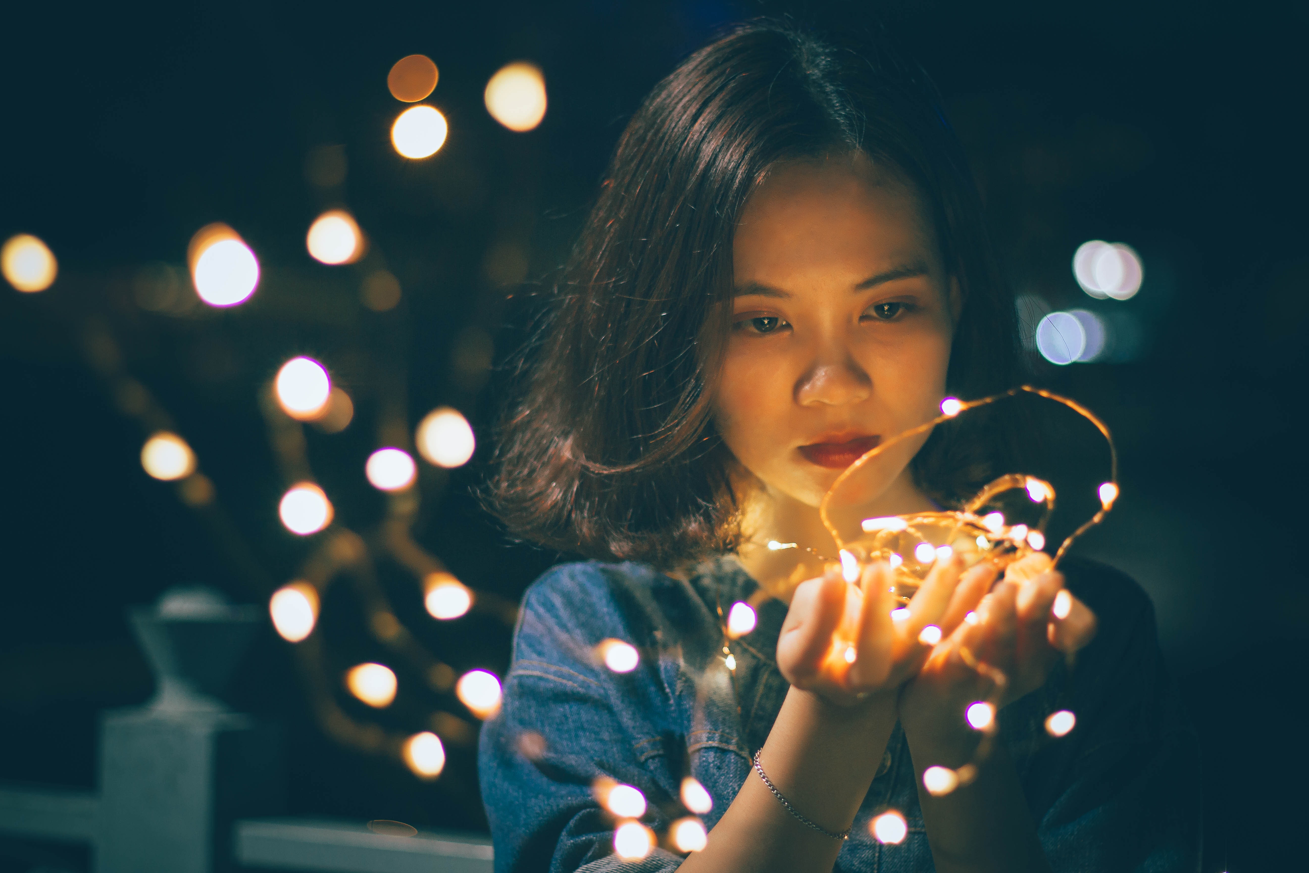 Child holding lit fairy lights