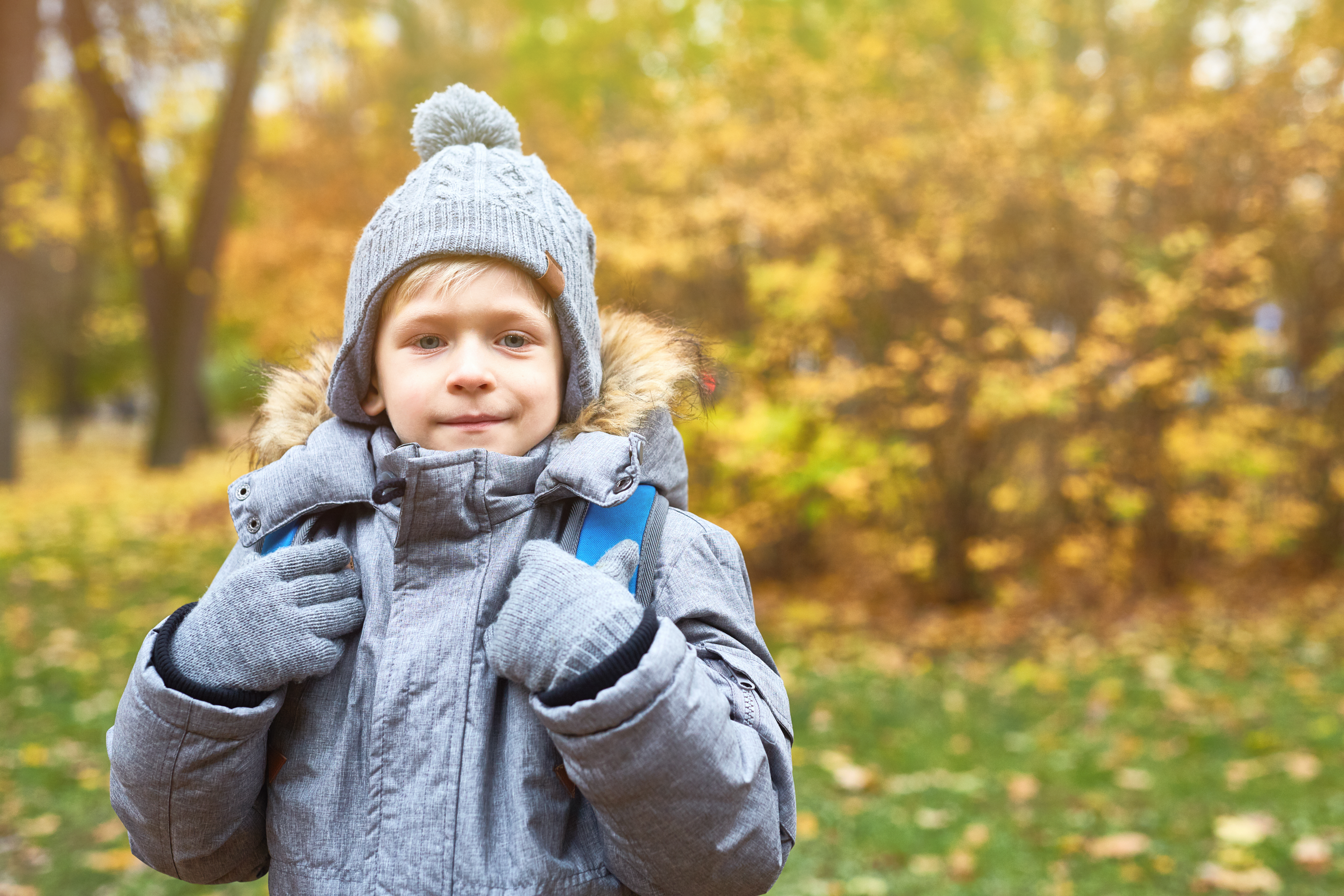 Boy in a park with a winter coat on