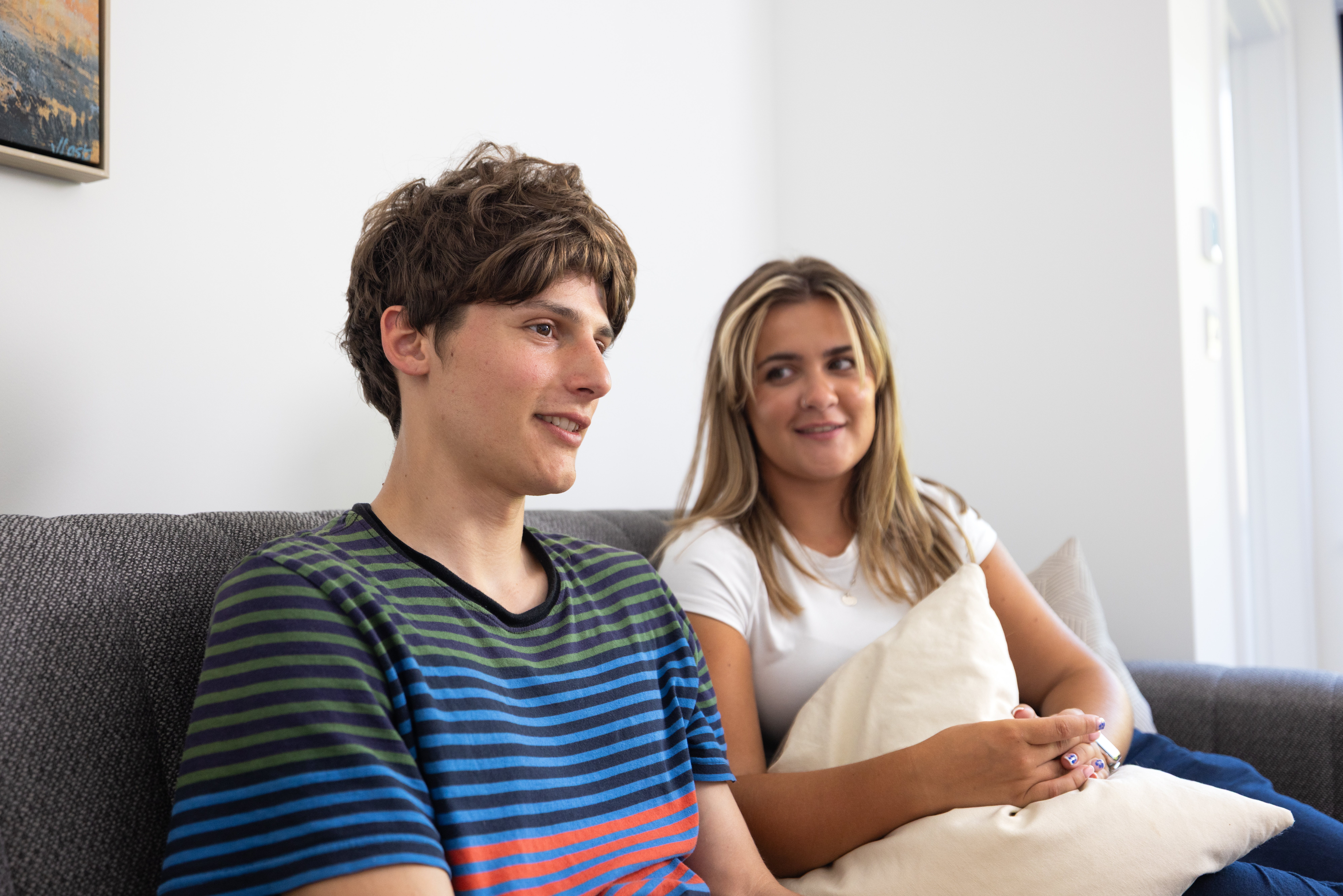 A young person sitting with an adult having a discussion
