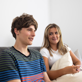 A young person sitting with an adult having a discussion